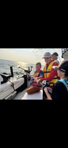 Four people fishing on the shore in ON