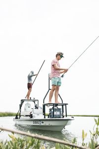Fishing boat with elevated platform and fishing rods in coastal waters near Awendaw SC