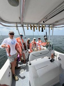 Fishing charter boat with multiple caught fish displayed on deck in Orange Beach AL waters
