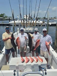 Red snapper fishing charter results displayed on boat deck in Orange Beach Alabama
