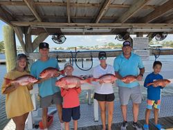 Group displaying red snapper catch at Orange Beach AL fishing dock