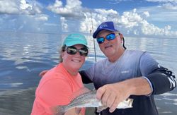 Arctic Grayling fish caught by two people in Pass Christian