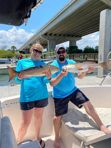Two anglers posing with their catch in Port Orange