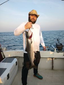 A person fishing in Kenosha, holding a 24-inch fish