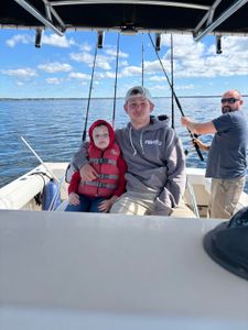 Three people fishing at Wells Harbor