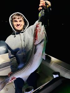 A pair of anglers with a big 28-inch fish they caught in ME