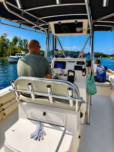 Fishing boat with navigation equipment and rod holders on water in Wells Harbor Maine