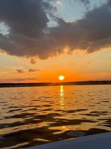 Sunset over calm waters at Wells Harbor ME with golden sky reflection