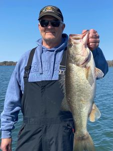 Angler holding large bass catch on boat in North Myrtle Beach SC waters