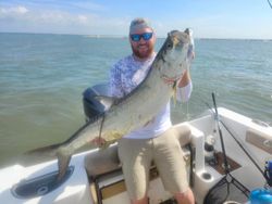 A single fisherman holding a big fish in North Myrtle Beach while fishing