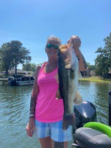 Angler holding large bass catch on boat in North Myrtle Beach SC waters