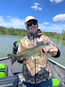 Angler holding caught bass on fishing boat in North Myrtle Beach SC waters