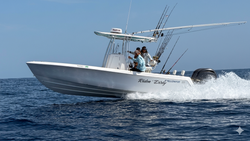 Fishing boat moving through water in St. Augustine FL with fishing rods mounted