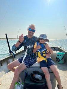 Fishing boat on ocean waters near Morehead City NC with fishing rods and cooler visible