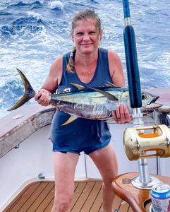 Angler holding caught fish on fishing boat deck in Morehead City NC