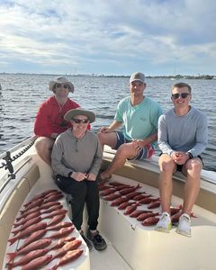Group of four people enjoying a fishing trip in Panama City Beach