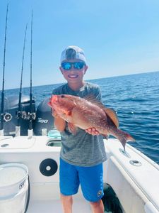 A fisherman holding a 16-inch catch in Florida