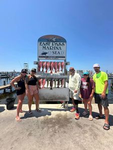 Five people enjoying a fishing trip in Destin
