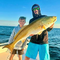 Two people fishing on the coast of FL