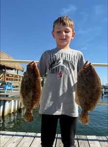 Two summer flounder and southern flounder caught while fishing in FL