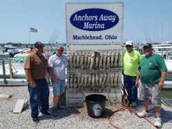 Four people enjoying fishing at lakeside location