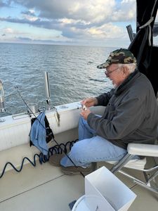 A person fishing by the lakeside in Marblehead