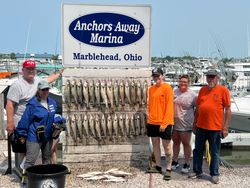 Five people enjoying a great day of fishing by the lakeside in Lakeside Marblehead