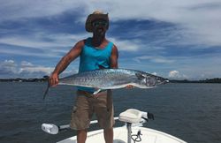 A fisherman reels in a king mackerel in Englewood