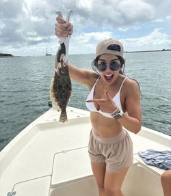 A person fishing for a summer flounder in Orlando