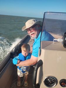 Fishing boat with steering wheel and gauges on open water near Corpus Christi TX