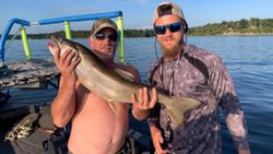 Anglers fishing in VT with a large 24-inch fish