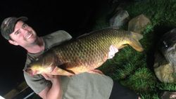 Photograph of a fisherman catching a common carp in Vergennes