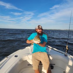 A person fishing in North Carolina with the text 'Best, great'