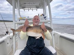 Angler fishing in North Carolina with two fish