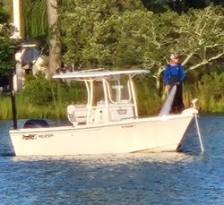 One fisherman enjoying the beautiful Oriental scenery while on a fishing tour