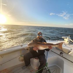 A person fishing for a redfish in North Carolina