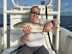 Light tackle triumph: Redfish hooked on a partly cloudy day!