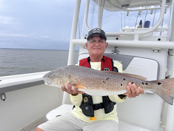 Big redfish reeled in on a partly cloudy day in Oriental!