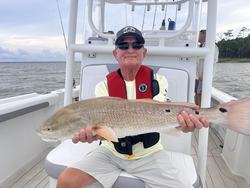 Big redfish reeled in using light tackle in stormy Oriental!