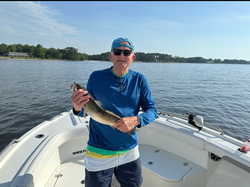 Hooked a tasty Spotted Weakfish on a vibrant day of fishing!