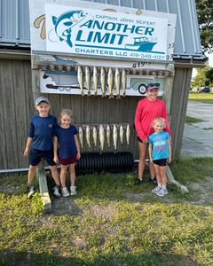 Four people enjoying a fishing trip at Lakeside Marblehead