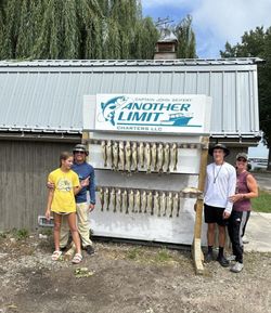 Four people enjoying a day of fishing at the lakeside in Marblehead