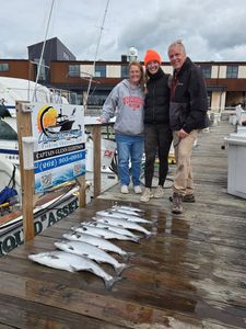 Successful chinook salmon fishing trip displaying catch on dock in Port Washington WI