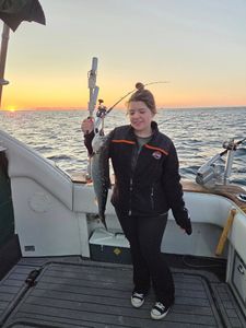 Fishing catch held up on boat at sunset in Port Washington WI