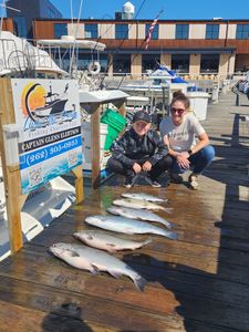 Fresh caught fish displayed on wooden dock in Port Washington WI after successful fishing charter trip