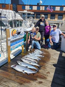 Successful fishing charter displaying fresh caught fish on dock in Port Washington WI