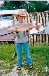 A person fishing in the waters of Oak Harbor