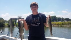 Two fishing rods with a person in the background, taken in Oak Harbor