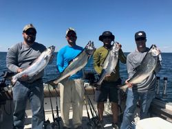 Four people fishing for large fish in Ogdensburg