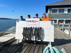 Two people fishing in NY with two big fish